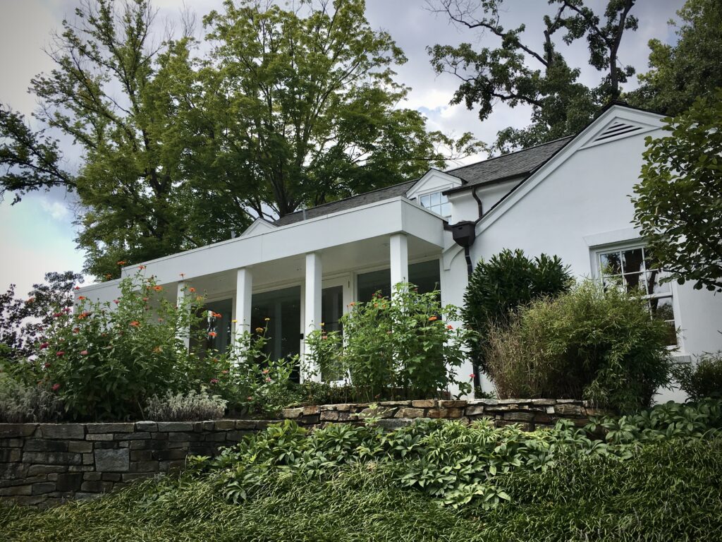 White building with plants in foreground