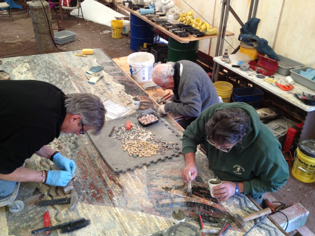 Mosaicists working to restore the right mosaic